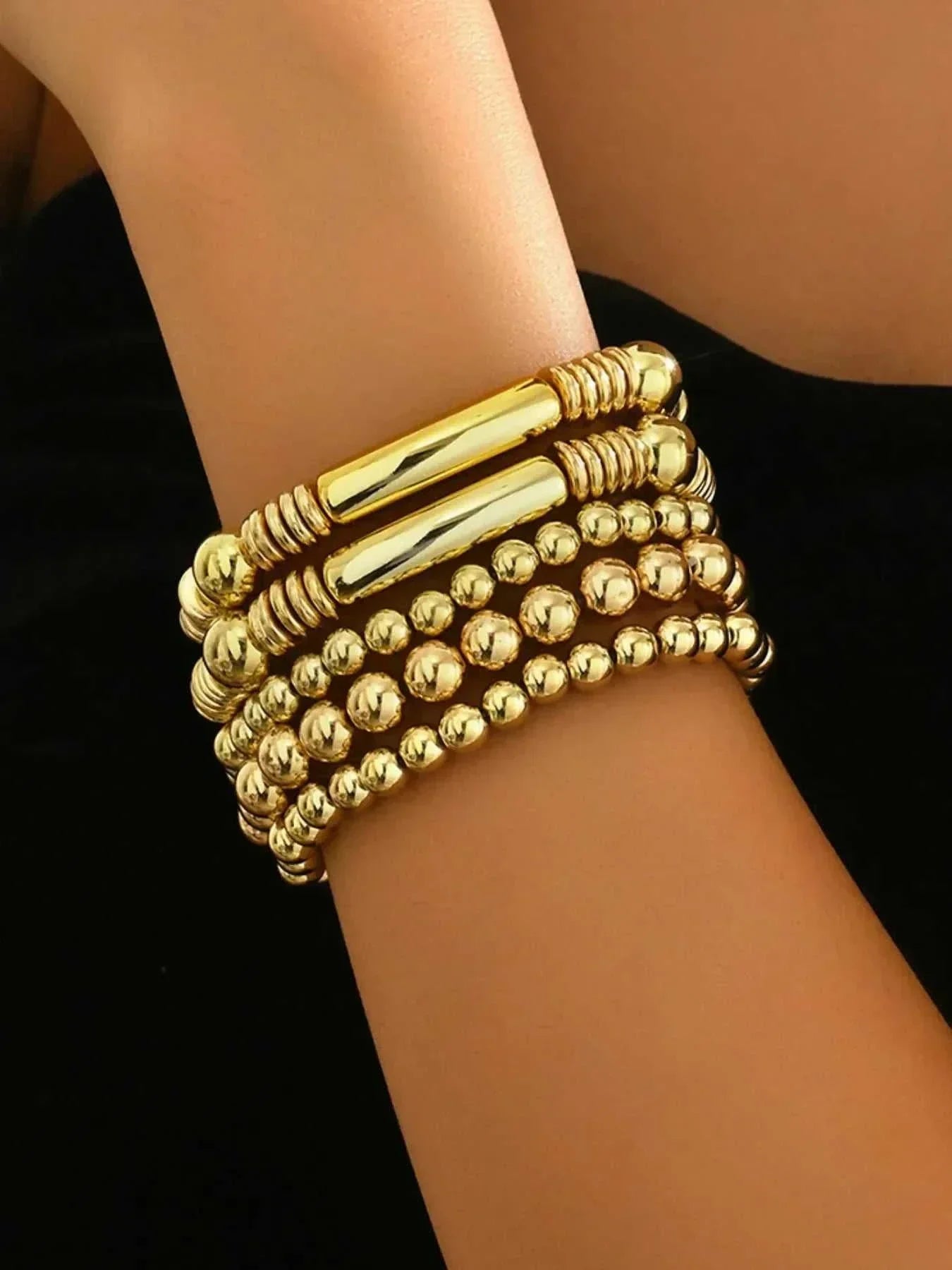 gold stainless steel beaded bracelet set stacked on wrist