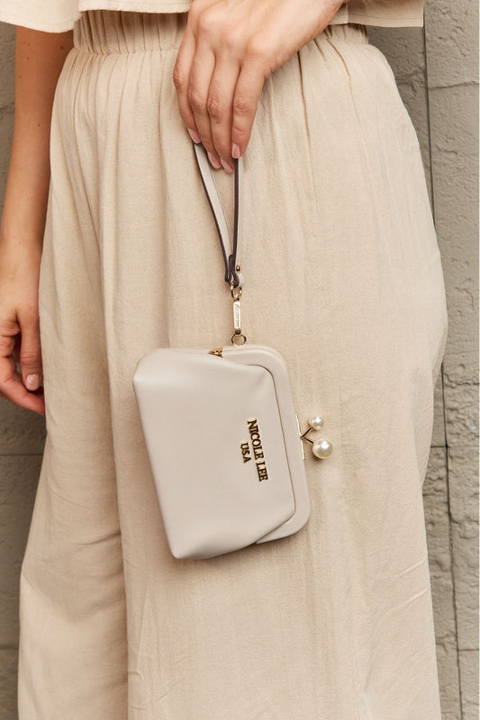 Nicole Lee USA Elise Pearl bag in light gray with pearl detail, stylishly held by a model