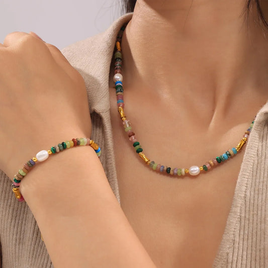Bohemian natural stone jewelry set featuring colorful beads and gold accents worn on the neck and wrist