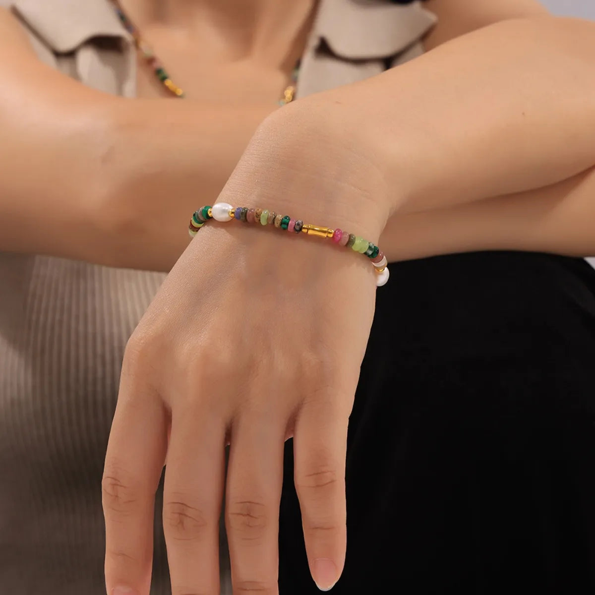 Bohemian natural stone jewelry set featuring a colorful beaded bracelet on a woman's wrist