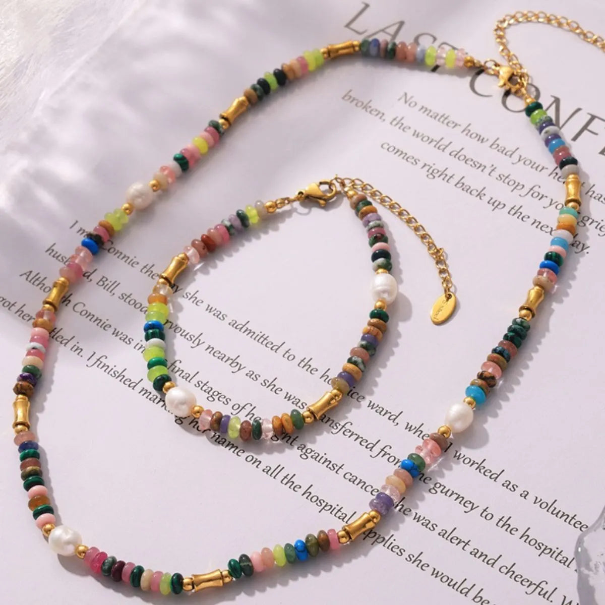 Bohemian natural stone jewelry set featuring colorful beads and pearl accents on a necklace and bracelet
