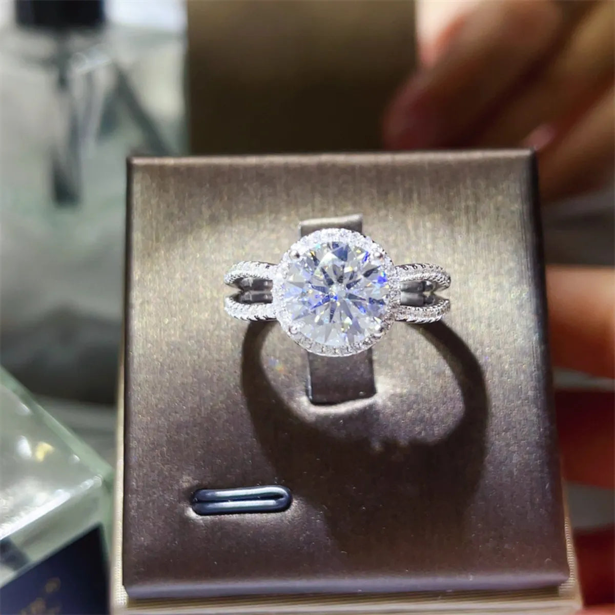 Stunning 2 carat moissanite engagement ring displayed in elegant box with intricate detailing
