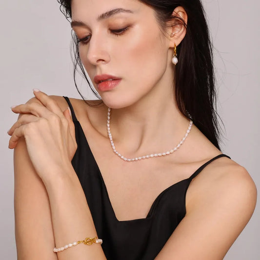 Elegant pearl jewelry set for women featuring a necklace, earrings, and bracelet in classic design