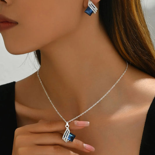 Stainless steel crystal jewelry set featuring a necklace and earrings with blue crystals