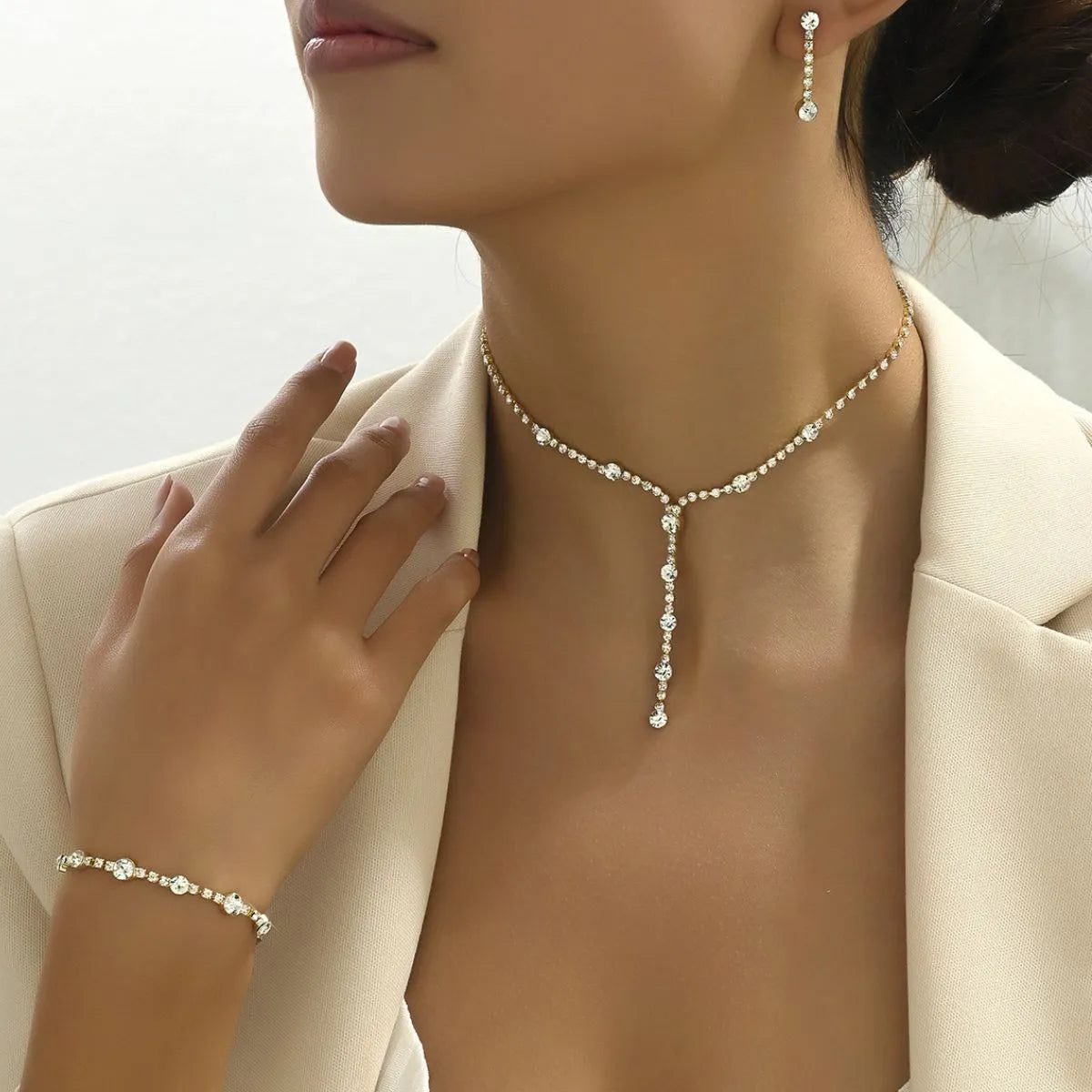 Elegant stainless steel zircon jewelry set featuring a choker, bracelet, and earrings for a sophisticated look